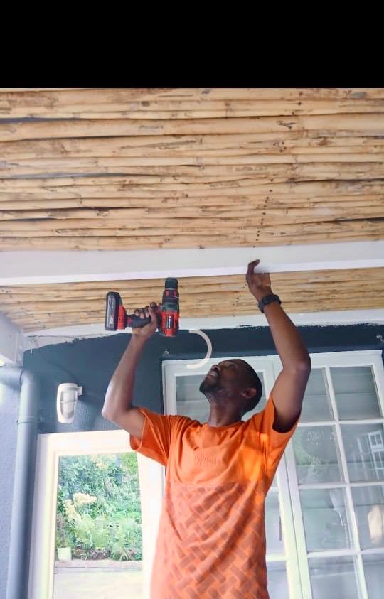 David working on an overhead fitting with a cordless drill